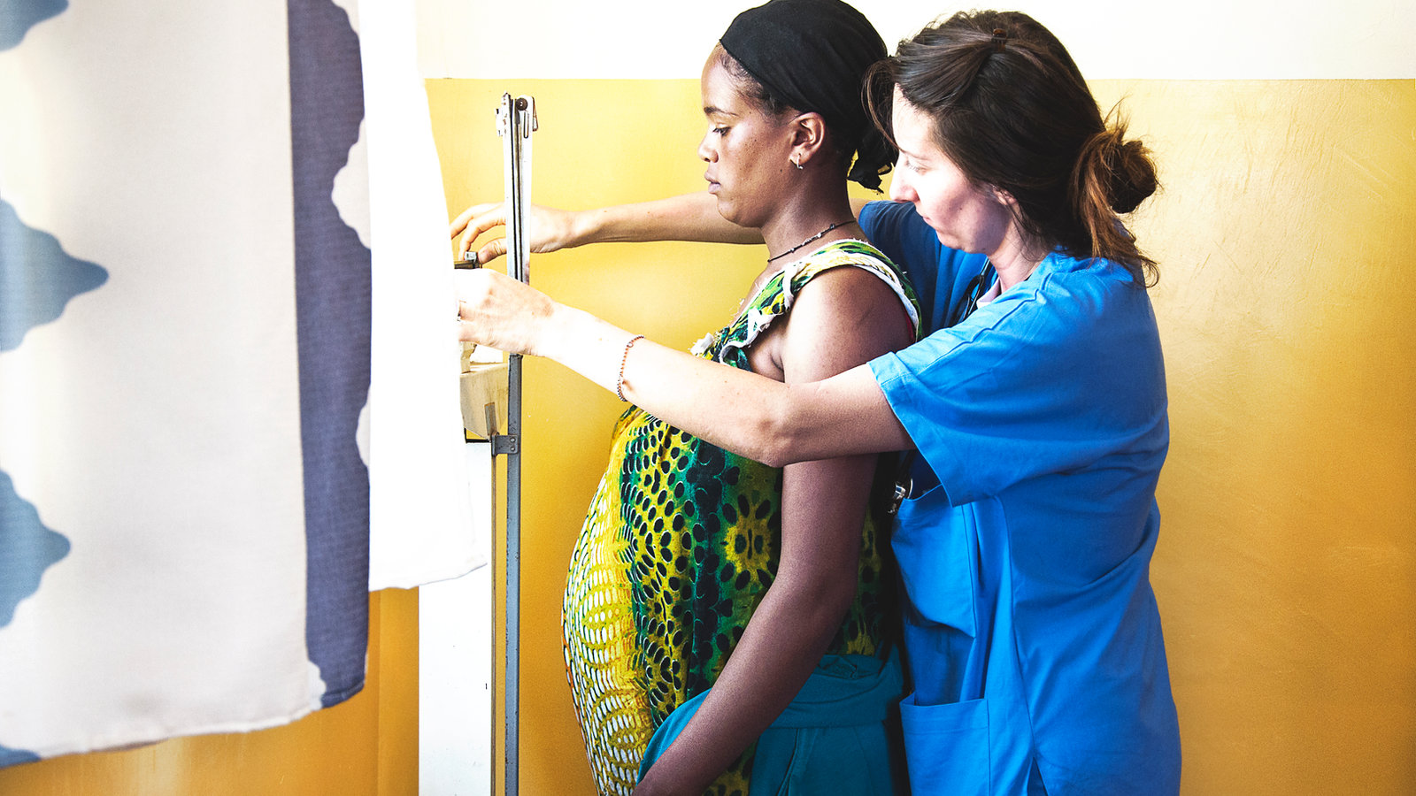 A doctor examining an expectant mother at a rural Ethiopian health center